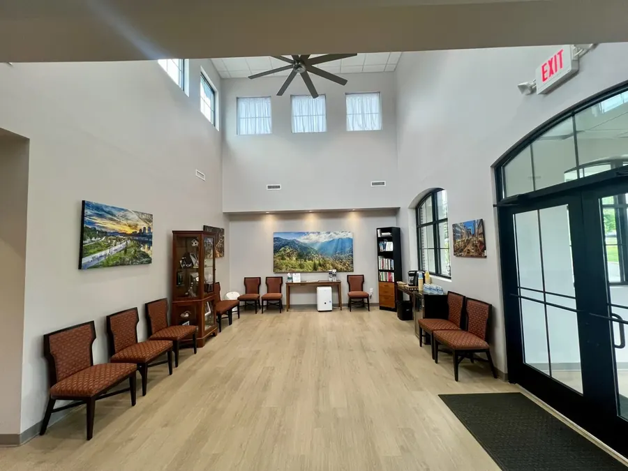 The waiting room at Dean Cosmetic Dentistry, with a vaulted ceiling and large mountain photographs.