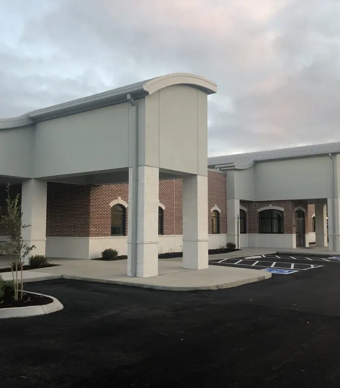 The covered entrance of the dental center at dusk.