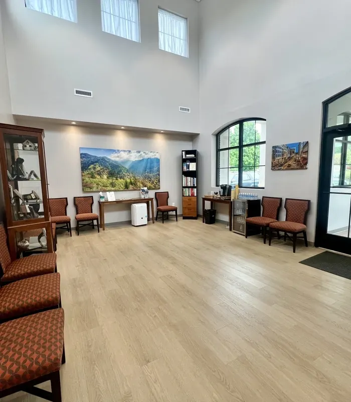 The waiting room at Dean Cosmetic Dentistry, with high windows and mountain photographs.